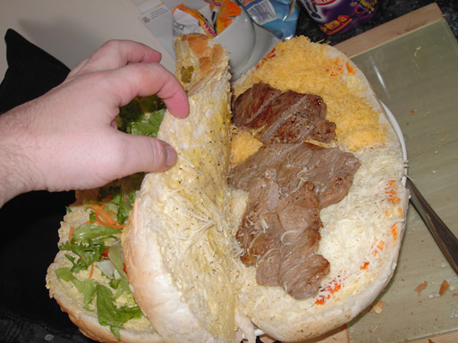Once you've trimmed the fat off, slice some of the steaks and insert them into the ground floor of your manwich