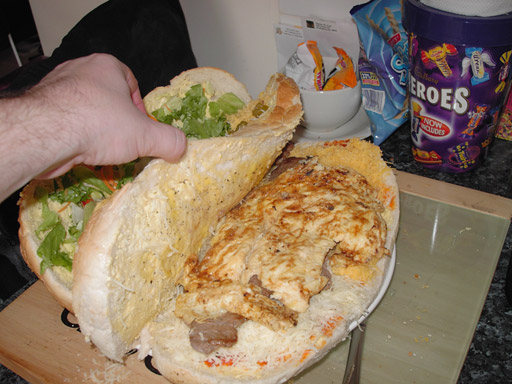 Add your now cooked omelette on top of the steaks on the ground floor layer of your manwich