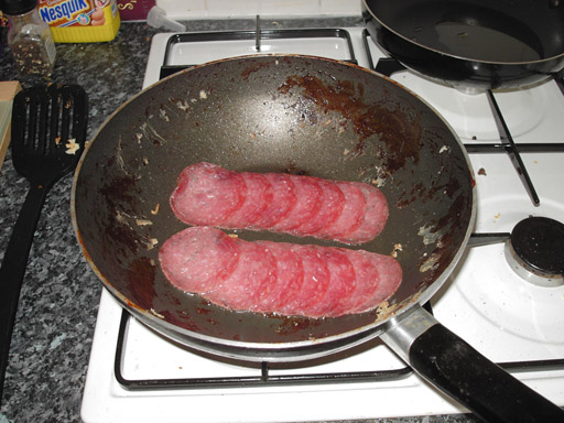Add your pack of salami to the hot frying pan and give a minute or two on each side